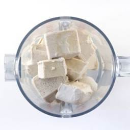 Therapeutiq cubes of frozen ice cream in the blender.